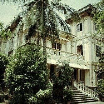 The Sociego House, a Tuason family residence formerly standing in Santa Mesa, screened by palms and mature planting.